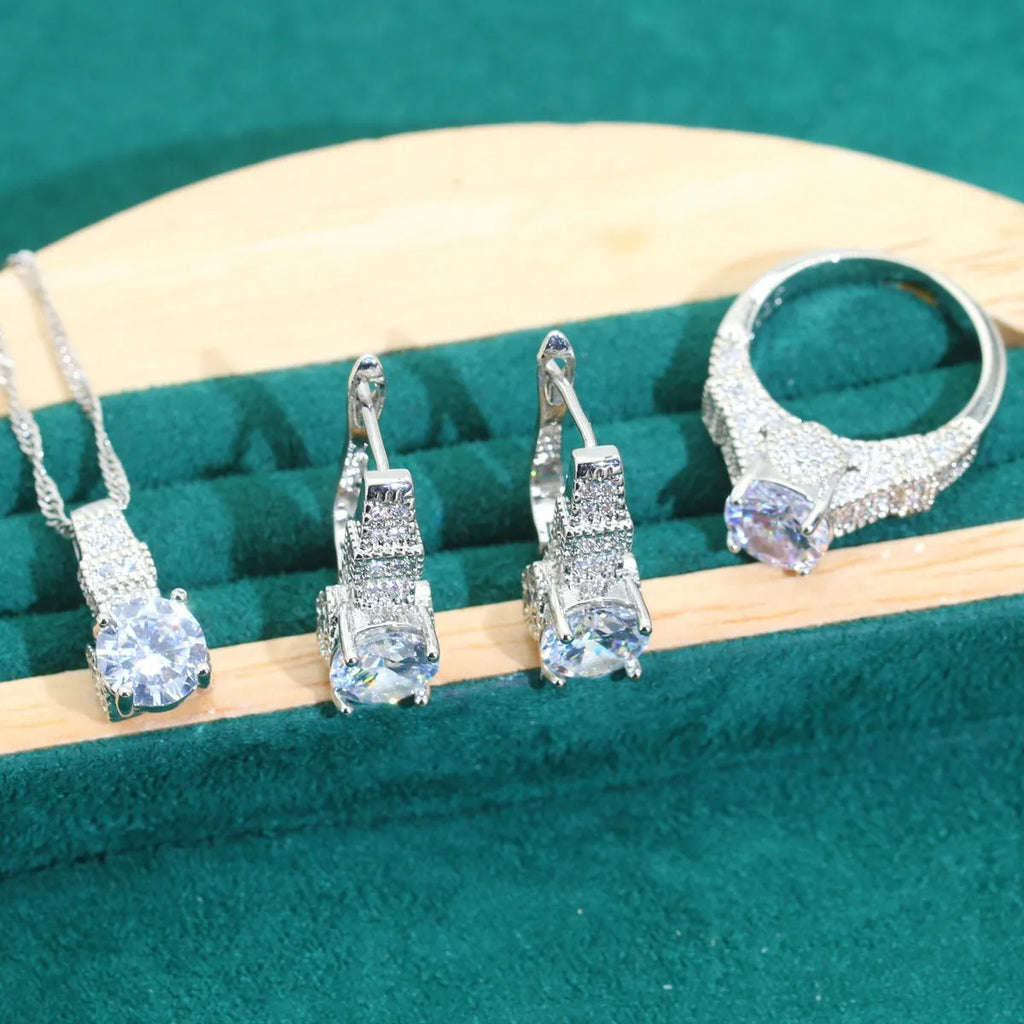 Bridal four-piece zircon jewellery set with necklace, bracelet, earrings and ring in water wave chain design.