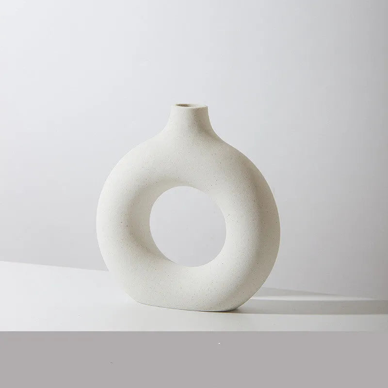 A simple modern frosted porcelain biscuit vase in a neutral colour, for flower arranging.