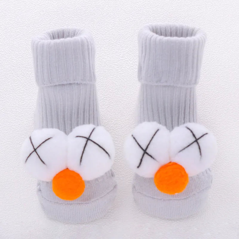 Cotton baby floor socks in assorted colours and prints like blue bow and pink stars on a size chart.