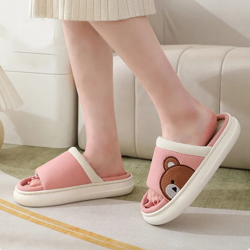 Pair of women's cartoon bear slippers with cotton linen upper and non-slip PVC sole, in light brown colour