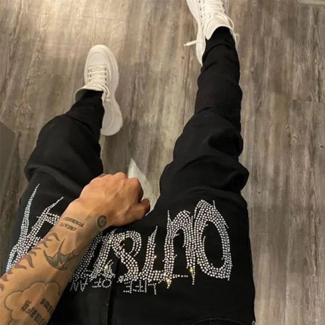 Men's black fashion ripped jeans with slim fit and distressed detailing, shown from front