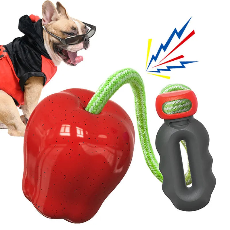 Green plastic squeaky apple dog toy for molar cleaning and outdoor fetch.