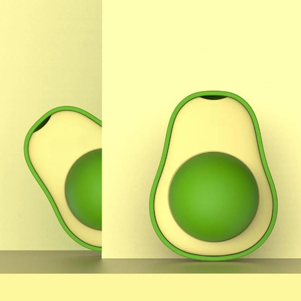 Avocado-shaped catnip wall toy attached to a smooth window with a silvervine ball for cat teeth cleaning