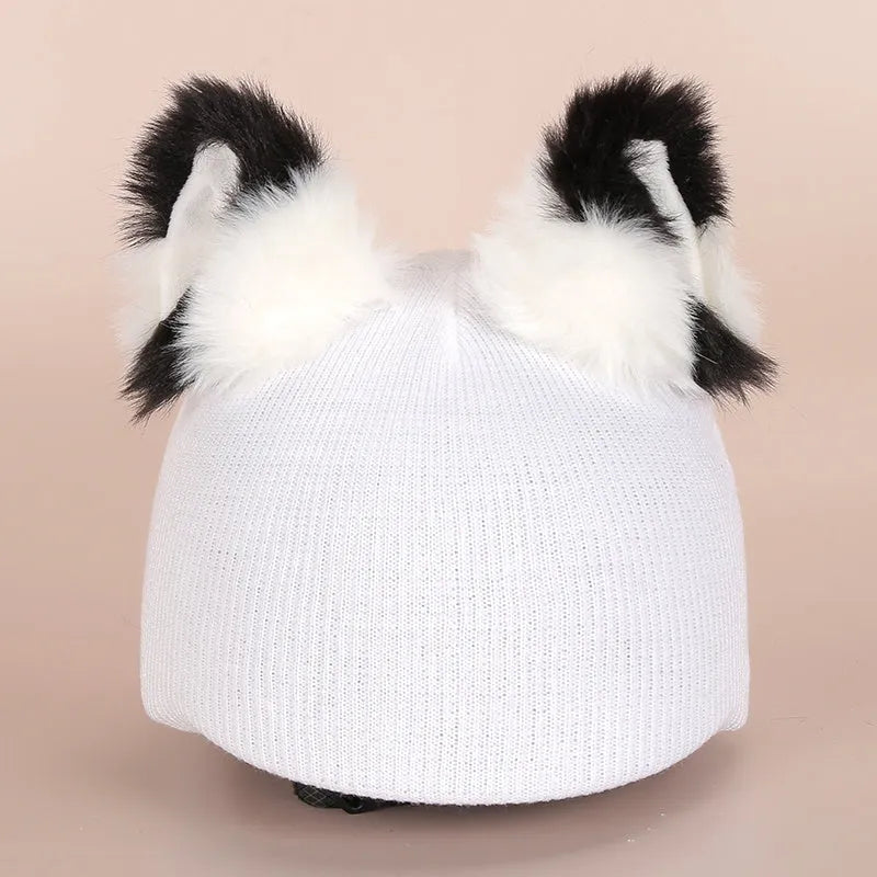 Soft plush cartoon character cover stretched over a pair of black on-ear headphones.