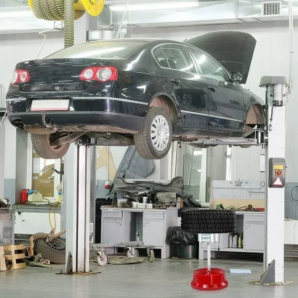 Portable aluminium hub balancer with bull's eye level on an enamel-finished base for tyre balancing.