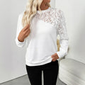 White long sleeve loose fit top with floral pattern on a hanger.