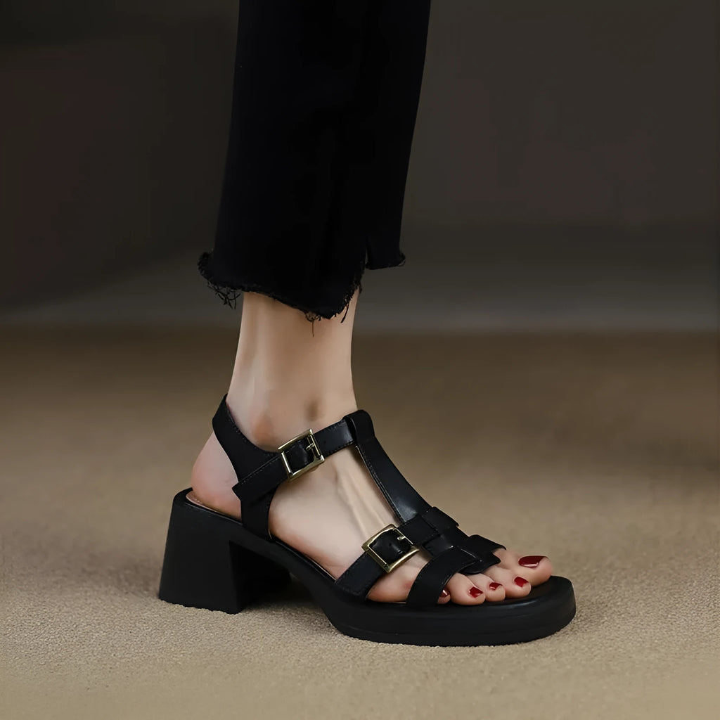 Black women's retro sandals with a T-buckle strap, chunky platform heel, and open square toe