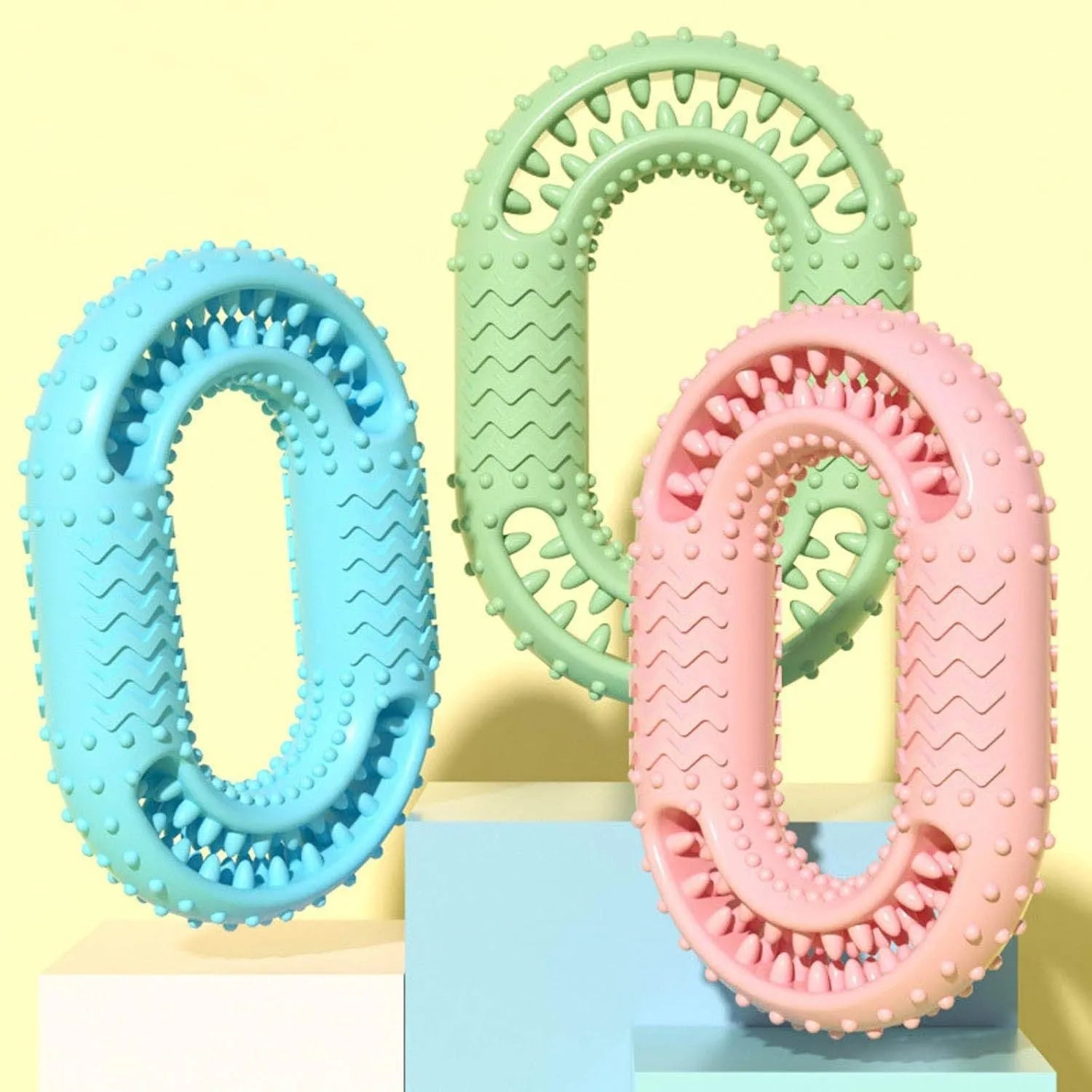 Blue, green, and pink O-ring shaped heavy chew resistant dog toy for aggressive chewers.