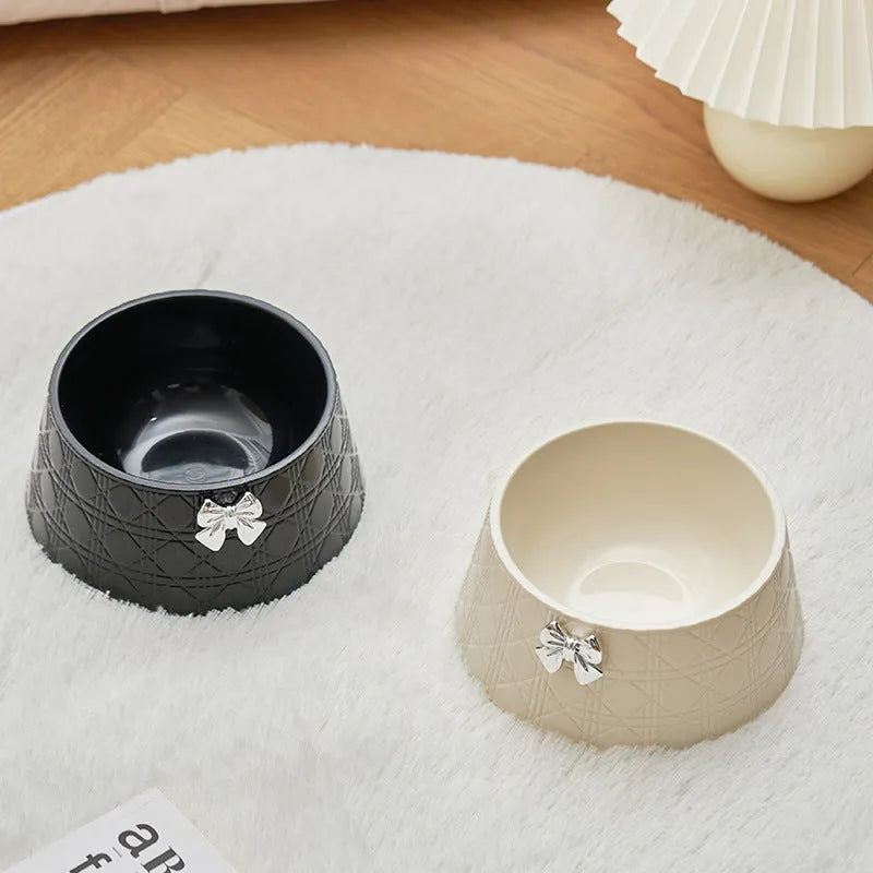 Pet food bowl with diamond pattern and bowknot decoration in black, purple or white with pink or silver bow