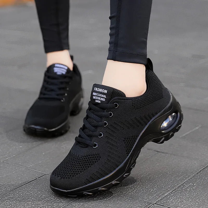 Women's red and black round toe lace-up mesh sneakers on a white background, showing the low-top profile and flat PU sole.