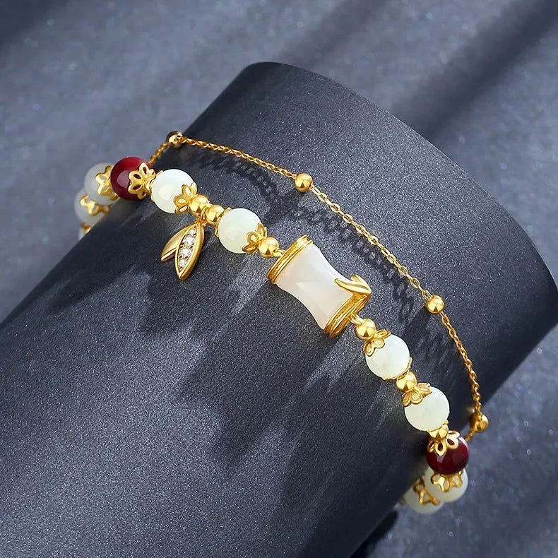 Bamboo-themed bracelet with a coloured glass flower and ruyi pattern in beige, green, light green, or white.