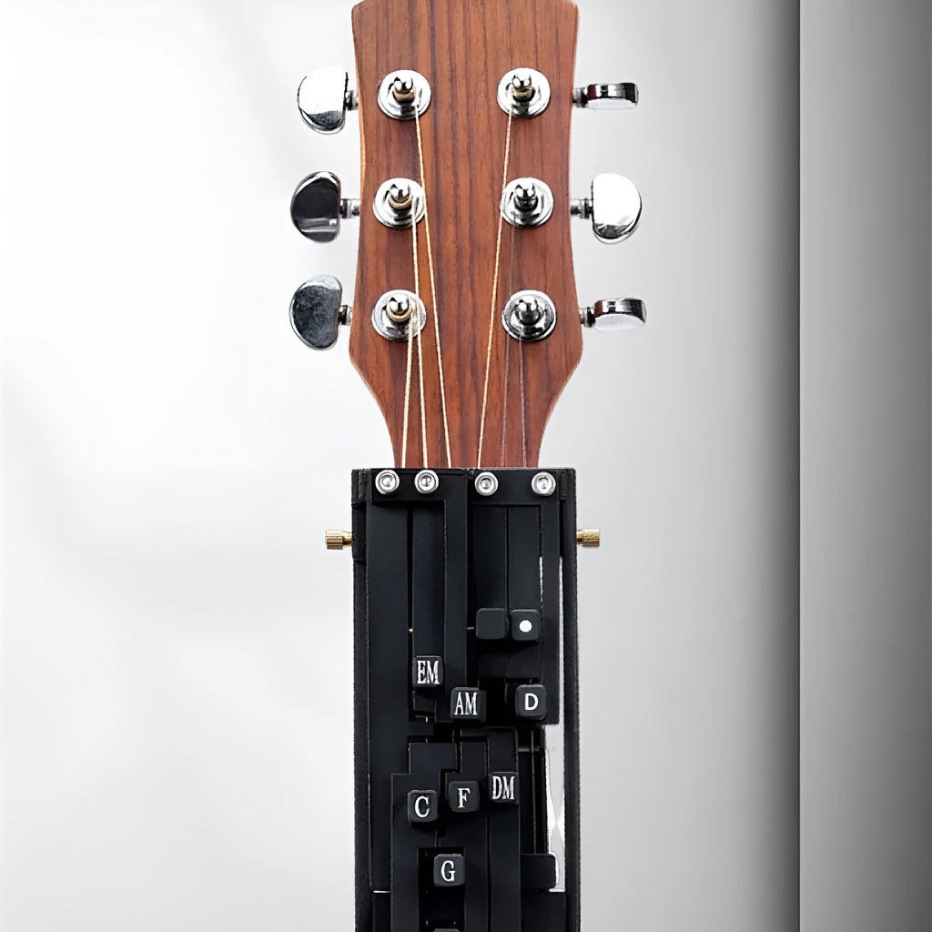 Black automatic chord device for folk guitar, showing the auxiliary gear mechanism for novice practice.