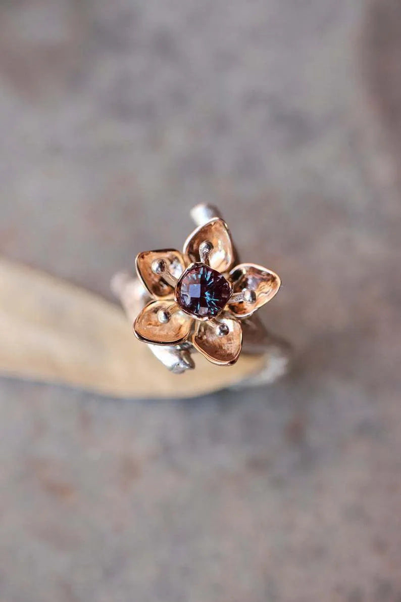 Silver two-tone floral geometric alloy ring for women on a plain background.