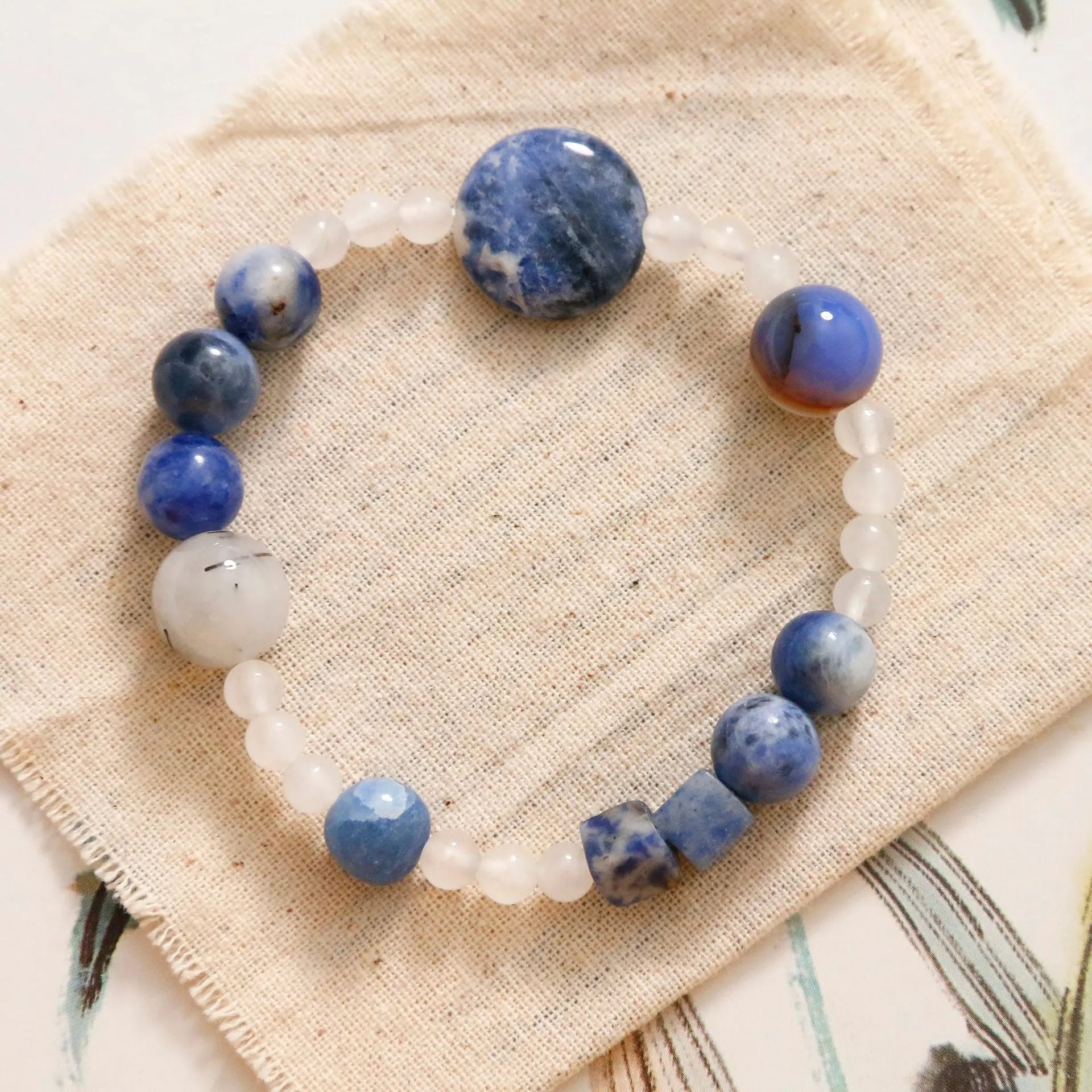 Hand-woven natural blue point stone and black hair crystal agate bracelet with geometric design