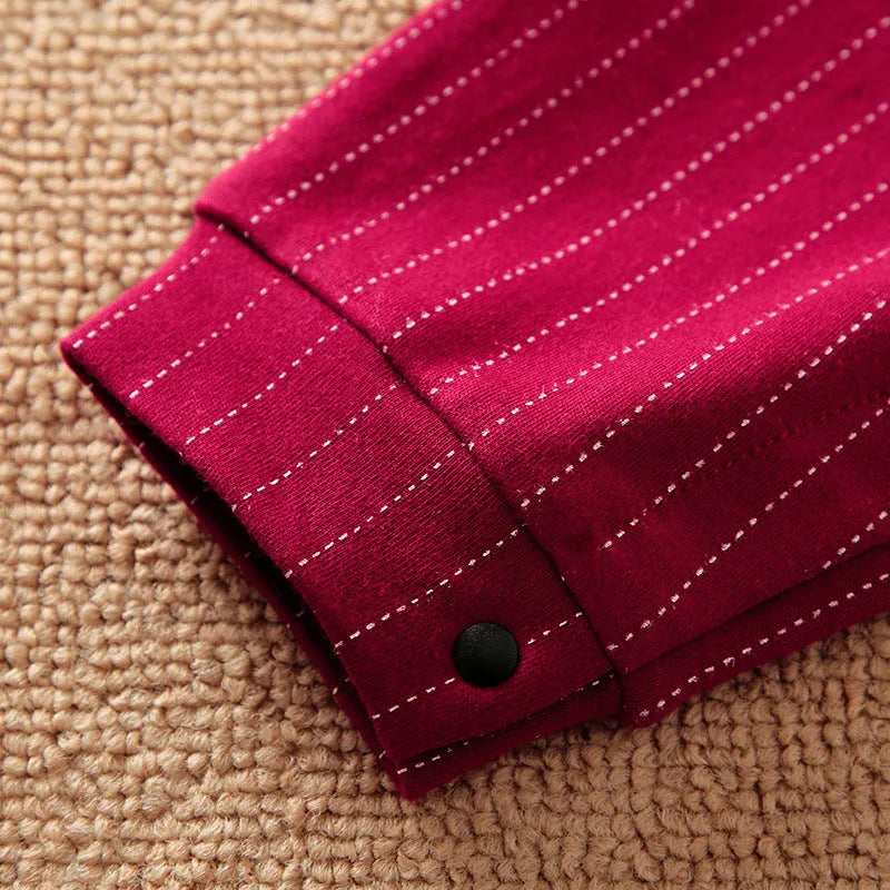 Wine red cotton baby boy romper suit with long sleeves and trouser legs.