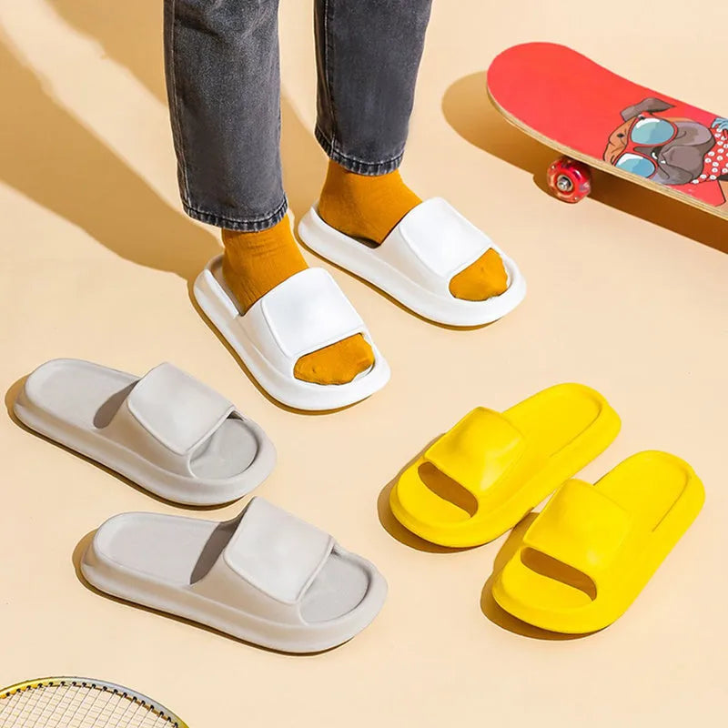 Pair of thick-soled white EVA flip-flop slippers with a non-slip patterned sole.