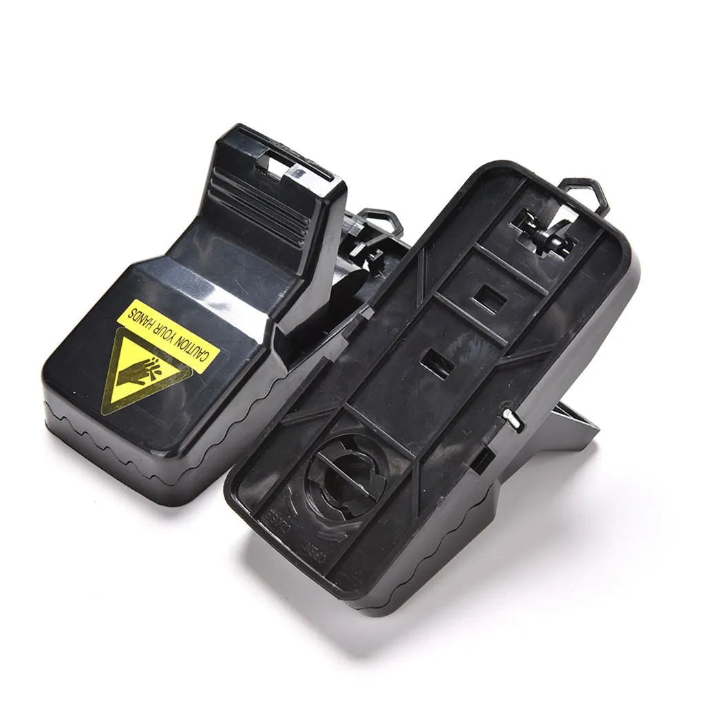 Six black plastic snapping mousetraps showing compact size and smooth surface