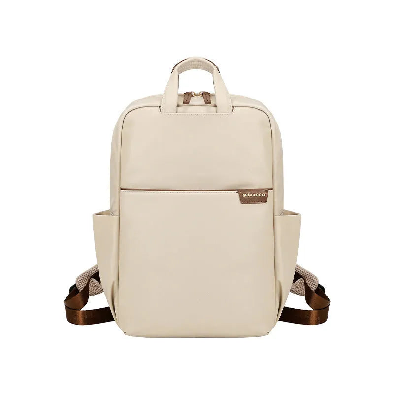 Large canvas travel backpack for women showing multiple internal compartments and zippered pockets