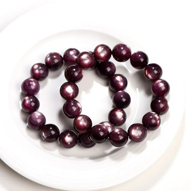 Natural purple lepidolite crystal bracelet with polished round beads, showing different size options.