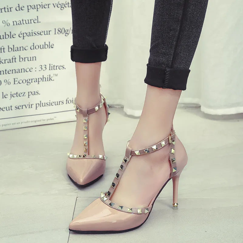 Studded pointed high heels with stiletto heel and buckle fastening in black