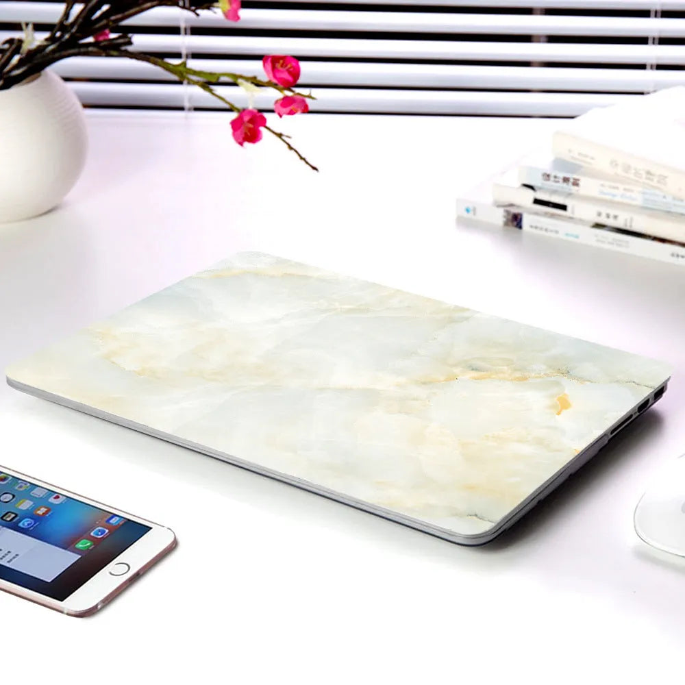 Plastic MacBook protective case in marble pattern showing front and side views