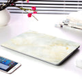Plastic MacBook protective case in marble pattern showing front and side views