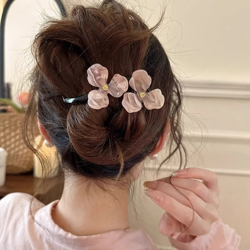 Close-up of a retro-style floral bobby pin hair clip with acrylic petals in a choice of colours.
