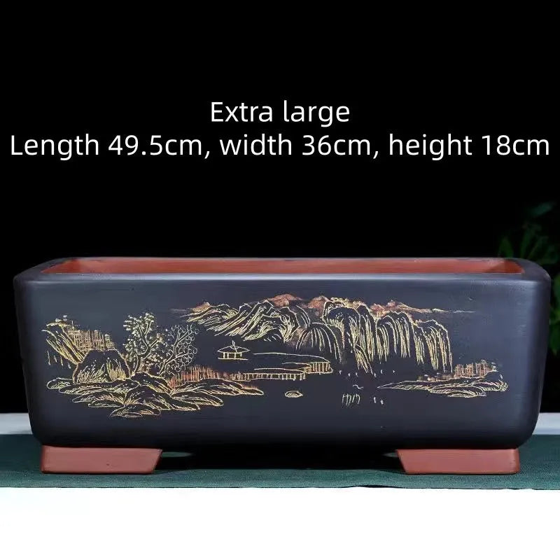 Handmade deep blue black rectangle purple clay bonsai pot on a wooden surface.