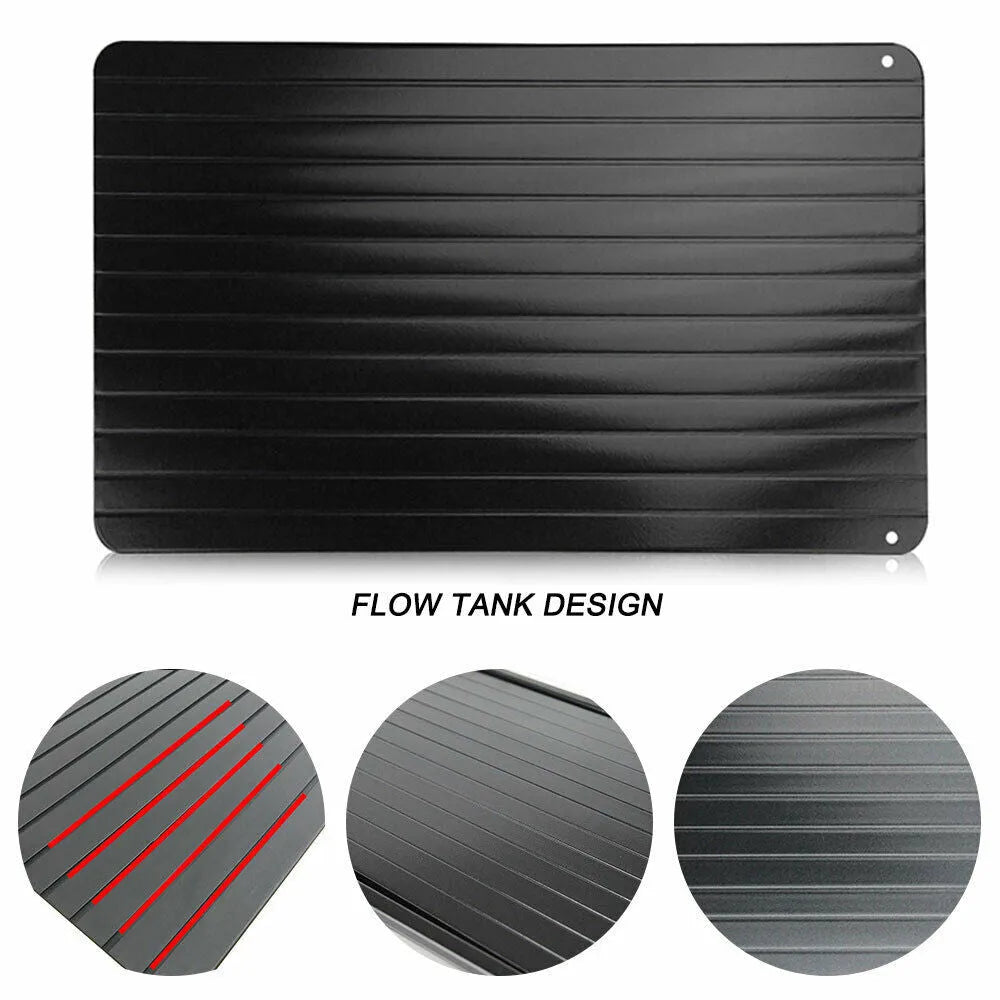 Black aluminium fast defrost tray for thawing frozen food on a kitchen counter.