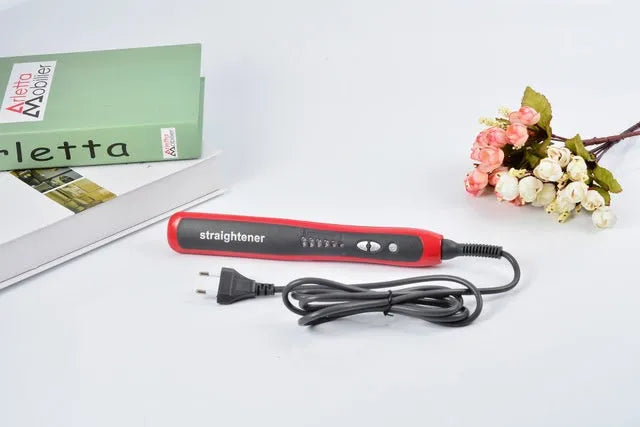 Black and red ceramic hair straightening brush with heated teeth and LED display on white background