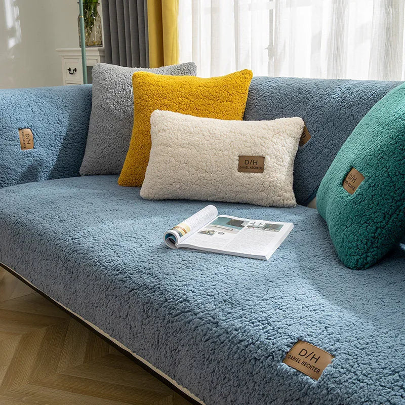 Solid colour plush sofa cover piece with anti-slip backing on a grey sofa