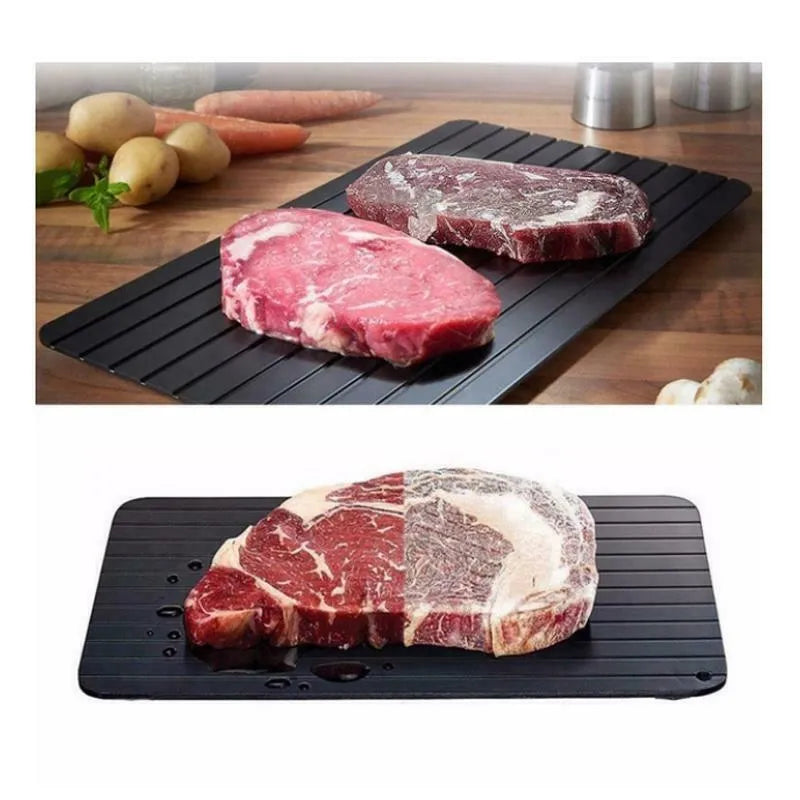 Black aluminium fast defrost tray for thawing frozen food on a kitchen counter.