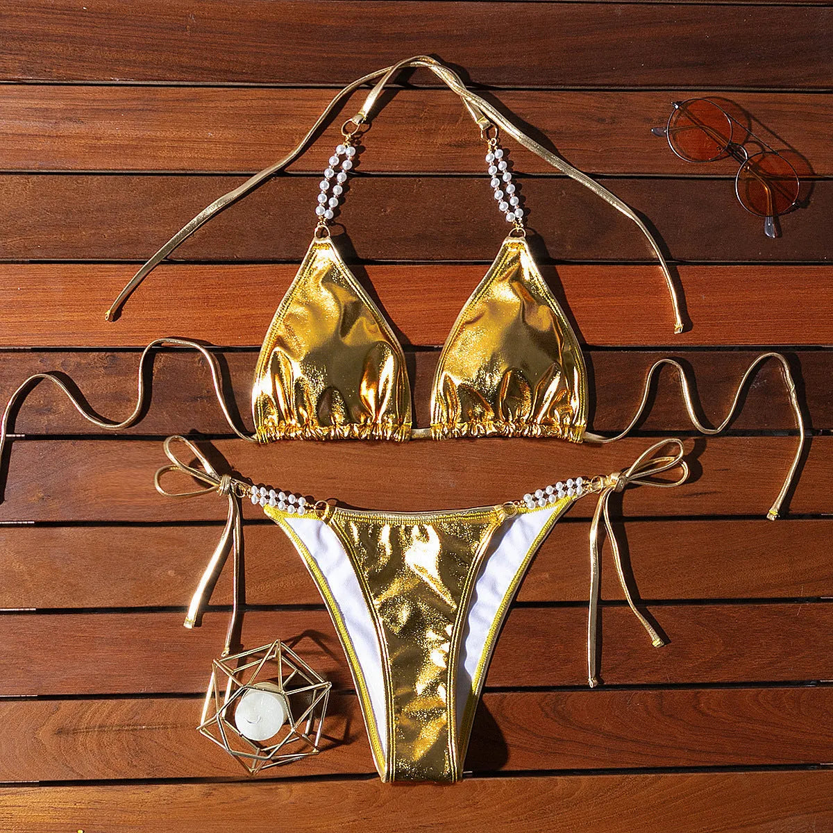 Gold halter lace-up bikini with pearl chain detail on mannequin showing front view