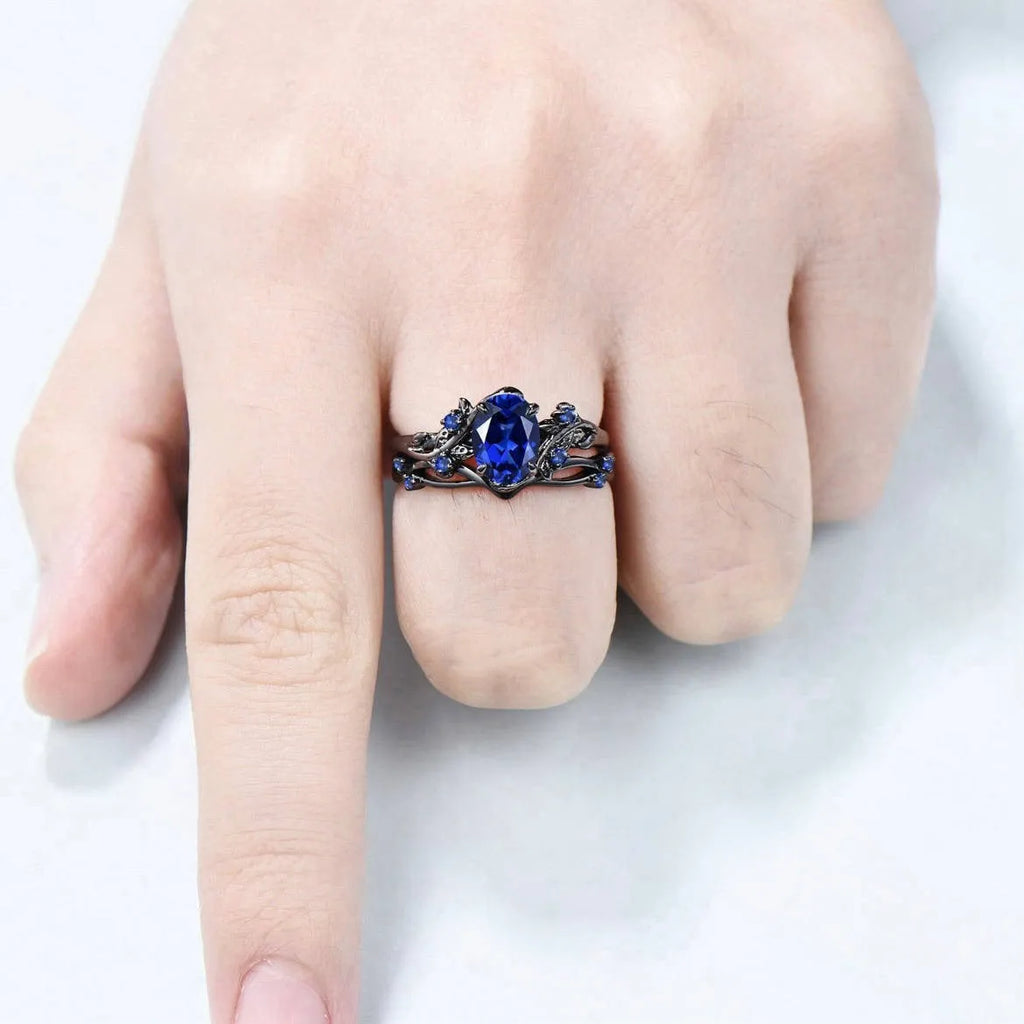 Gun black geometric copper women's ring with an inlaid navy blue rhinestone, shown in size 10.