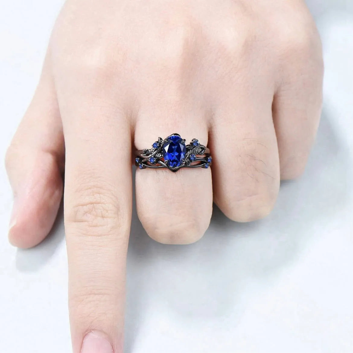 Gun black geometric copper women's ring with an inlaid navy blue rhinestone, shown in size 10.