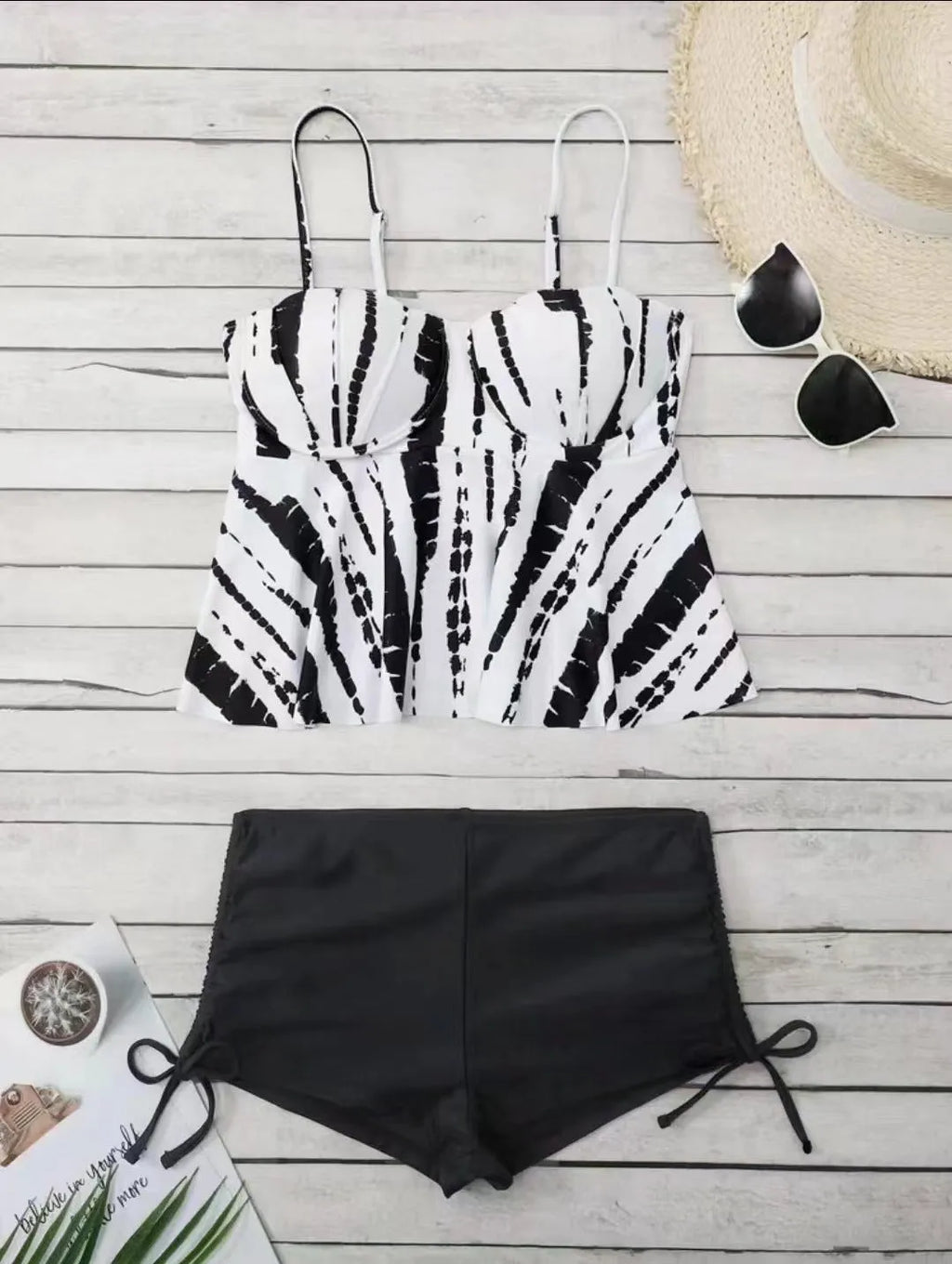 Women's blue printed bikini swimsuit top and shorts set on a mannequin.