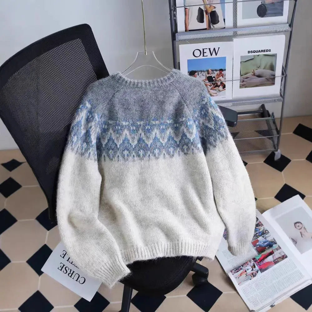 Women's beige jacquard patterned thick knit sweater coat with a loose fit and long sleeves.
