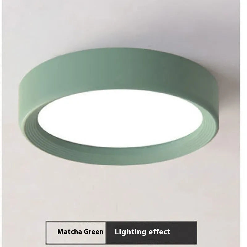 Ultra-thin surface mounted LED downlight in a choice of seven shell colours including black, white, gold, and pink.