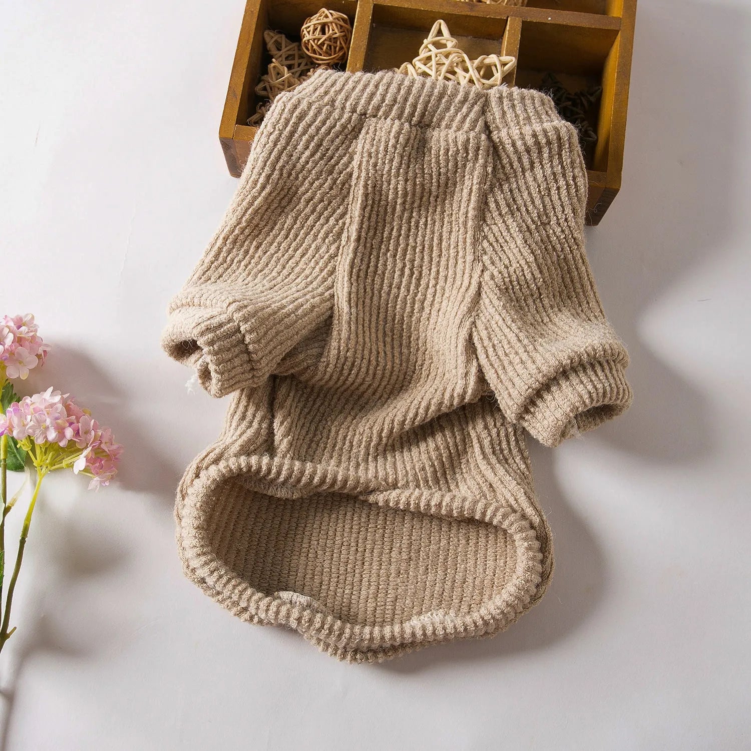 Brown cloth pullover sweater on a small dog, showing casual style and fit.