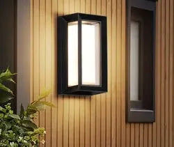 IP65-rated outdoor wall light with acrylic lampshade and aluminium body for garden use.