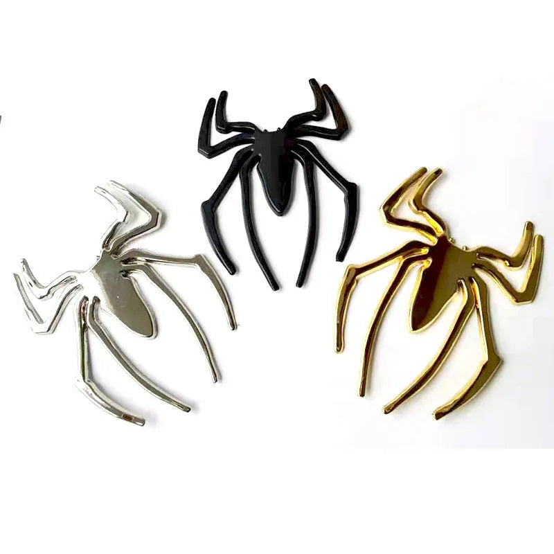 Three-dimensional metallic spider sticker in gold, silver, black, and red colours