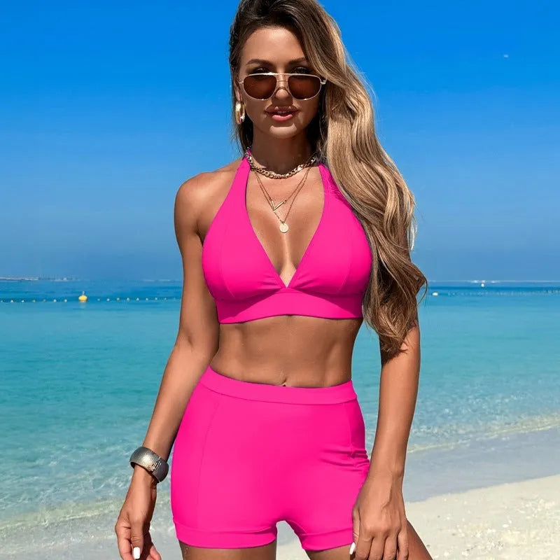 Women's black bikini swimsuit laid flat, showing sleeveless design and split bottom.
