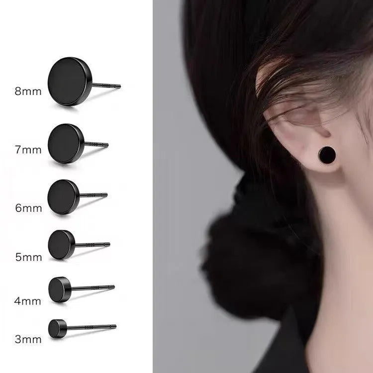 A pair of simple round flat stud earrings in sterling silver, shown in silver and black finishes.