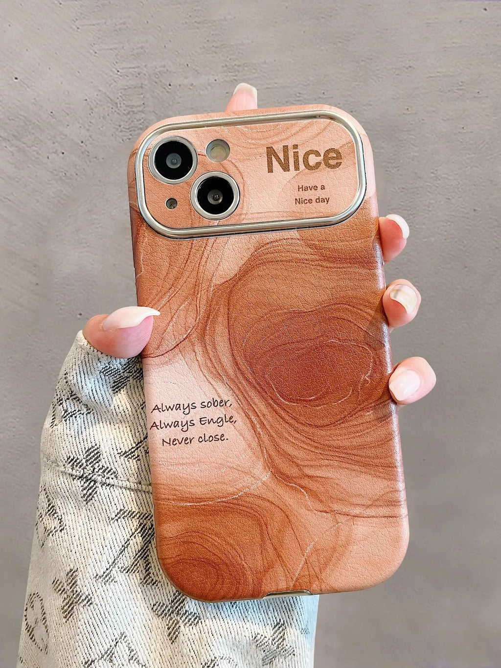 Large window lambskin silicone phone case in coffee colour with three-dimensional relief pattern compatible with iPhone