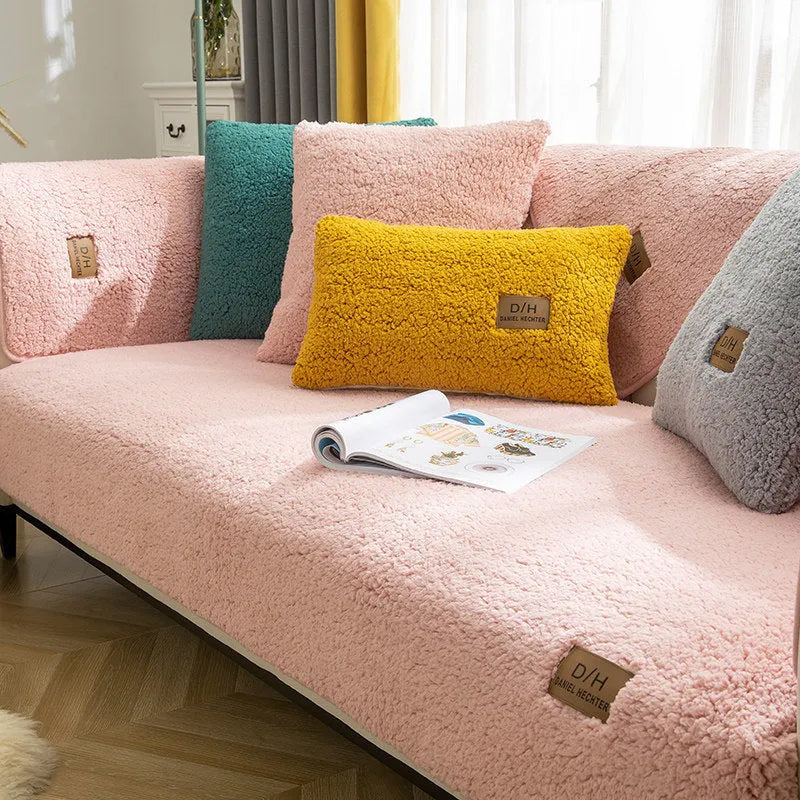 Solid colour plush sofa cover piece with anti-slip backing on a grey sofa