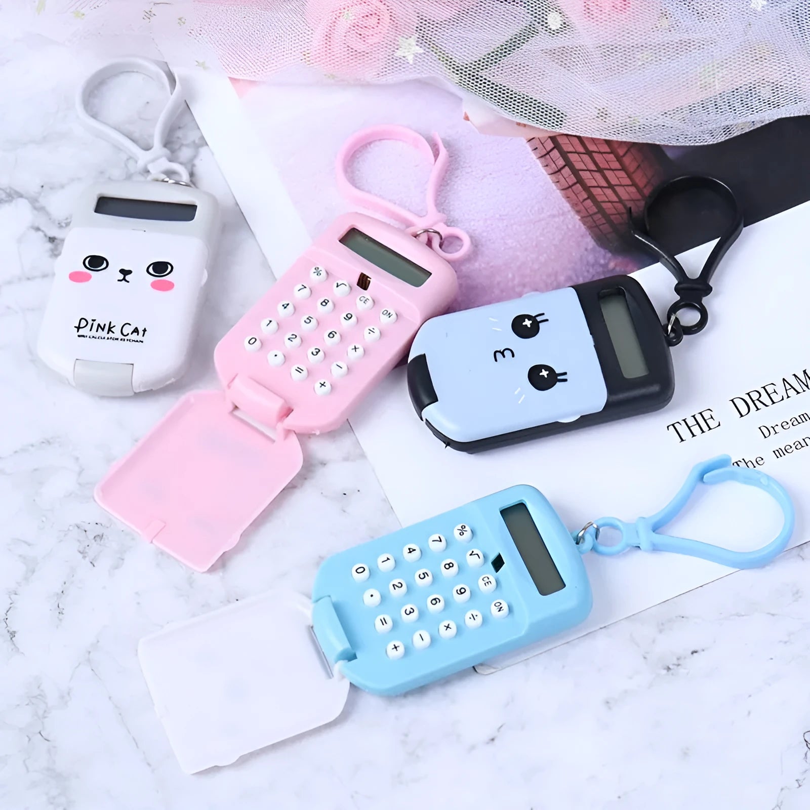 Creative cookie-shaped cute mini calculator in pink with key ring on a white background