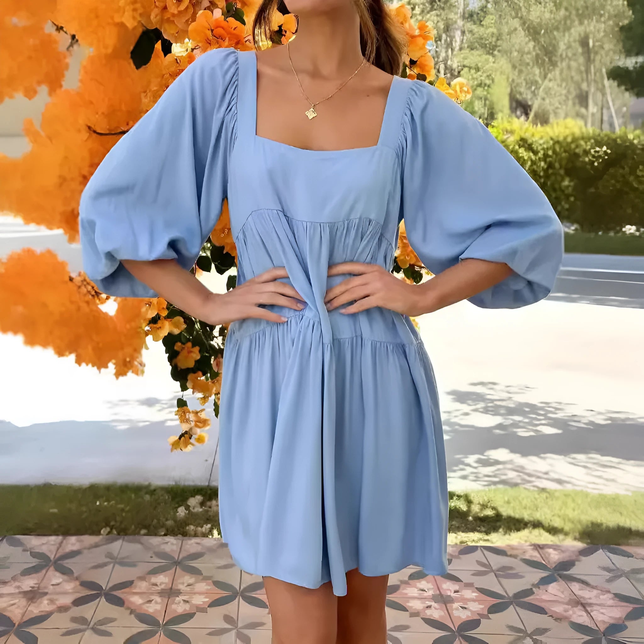 Orange red children's backless pullover dress with puff sleeves and a square collar on a mannequin.