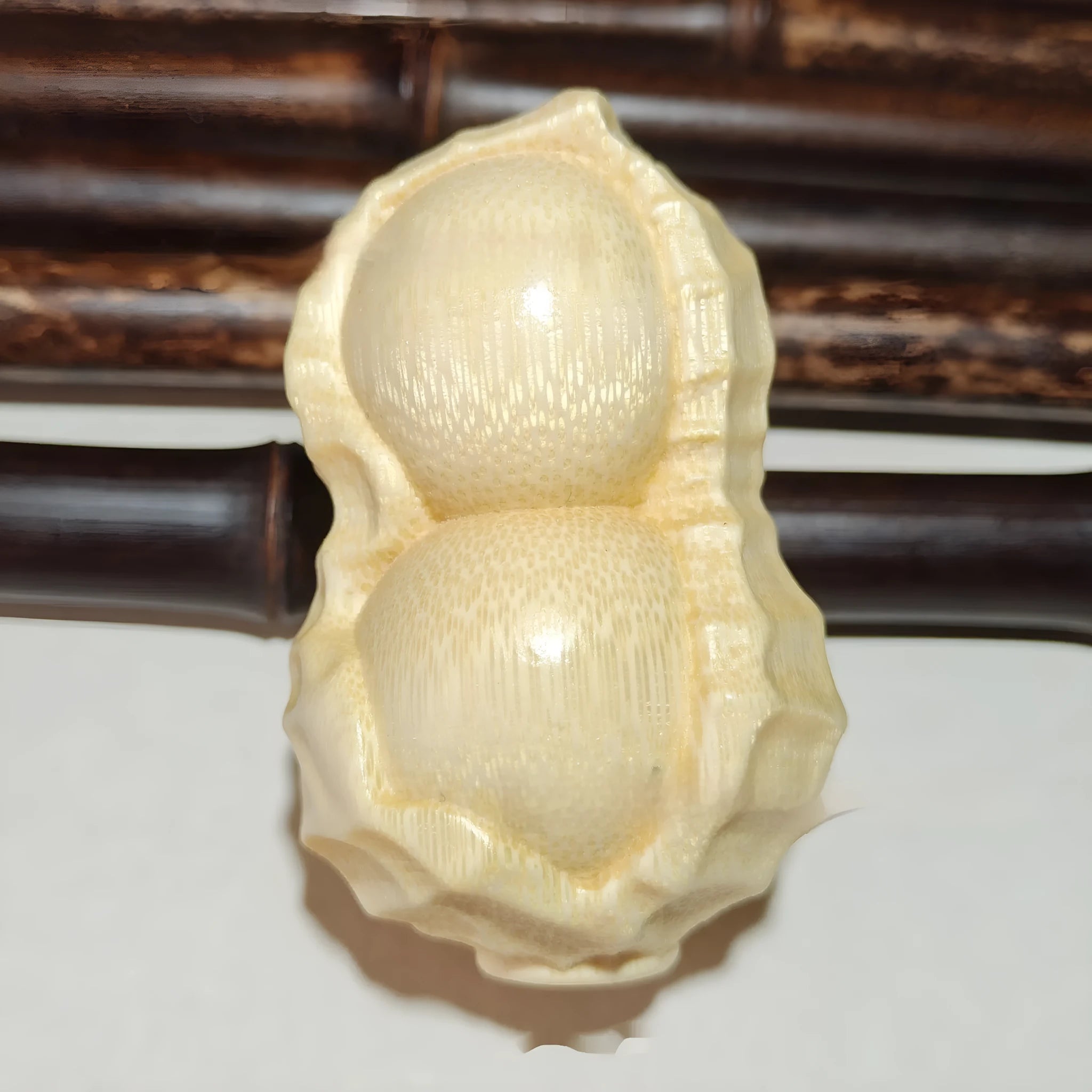 Solid bamboo carving peanut ornament on natural background