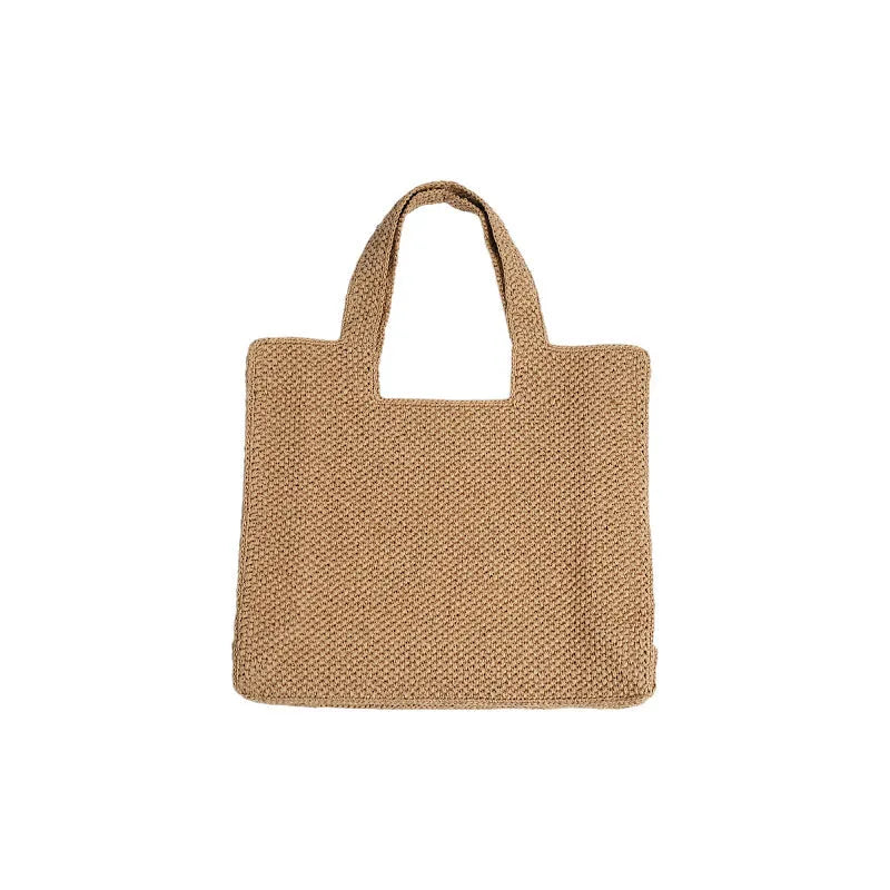 Straw woven bucket tote bag in khaki colour showing double shoulder straps and woven texture detail