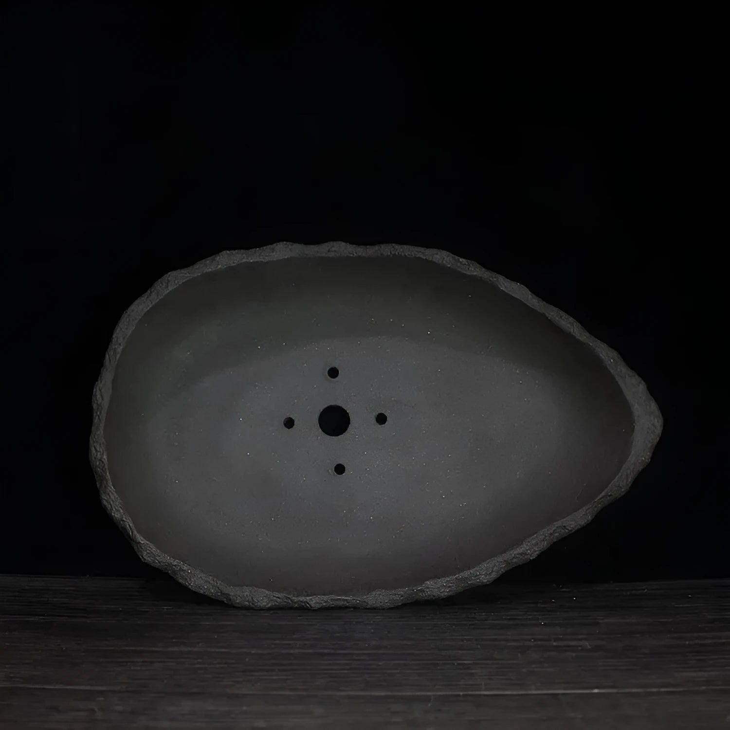 Handmade purple clay flower pot showing natural texture and colour variations
